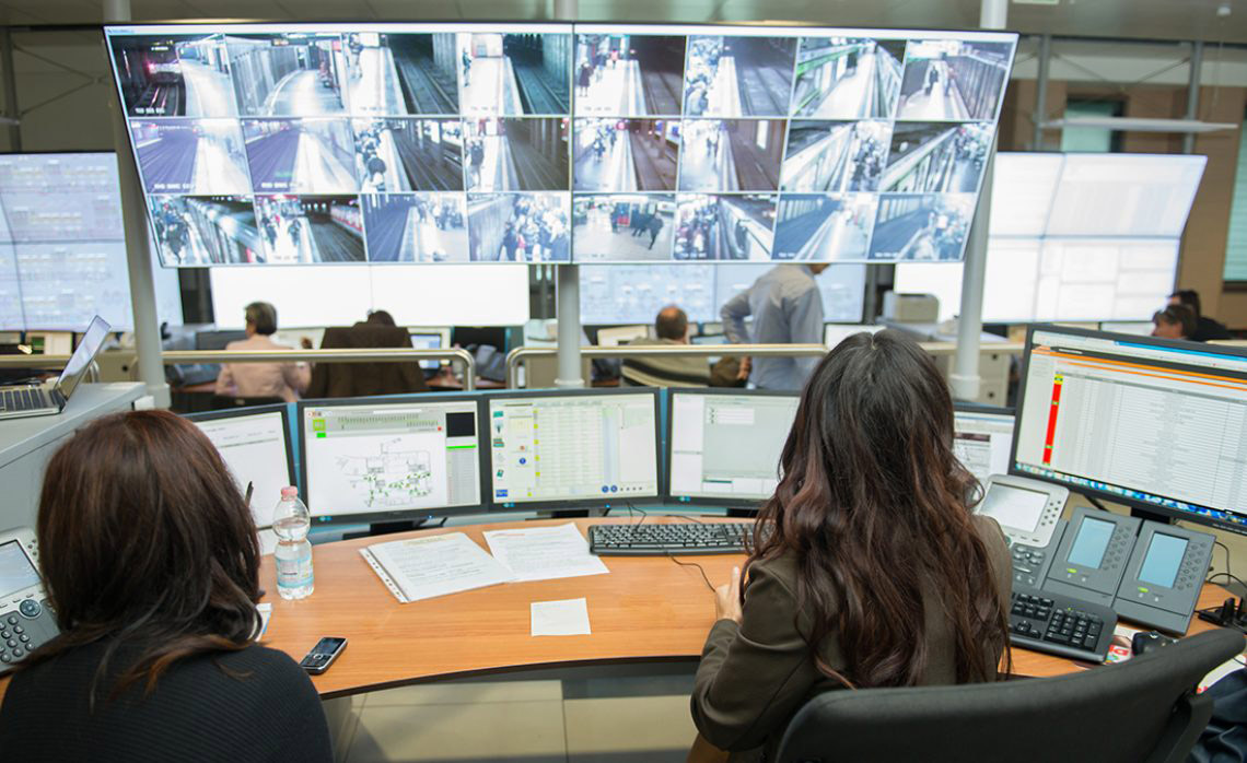 Security operations center with operators monitoring AI-enhanced surveillance feeds